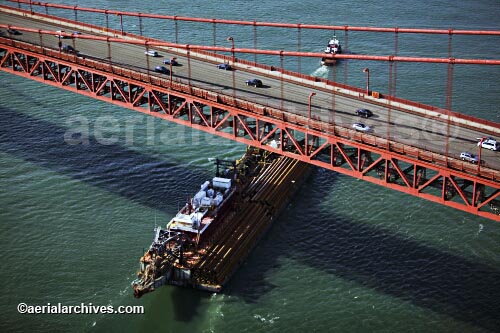 © aerialarchives.com oblique aerial photograph of a tug boat pulling a barge passing under the Golden Gate bridge,  
AHLB2121.jpg