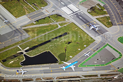 aerial photograph of heavy air traffic at San Francisco International airport's dual runways, sfo, © aerialarchives.com APF7RX, AHLB2352